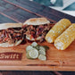 Pulled pork sandwiches seasoned with Chicken & Pork Rub, with corn and pickles