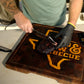 Slicing a smoked brisket on the TX Brew & Barbecue cutting board