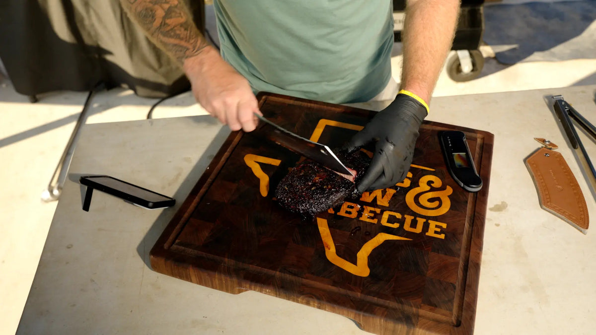 Slicing a smoked brisket on the TX Brew & Barbecue cutting board