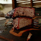 Smoked Trisket slices showing bark and smoke ring